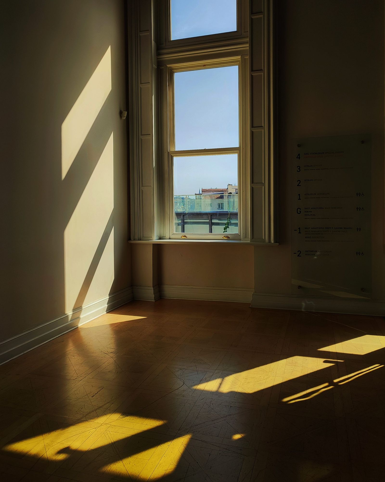 Sunlight falling across a wooden floor through a tall window