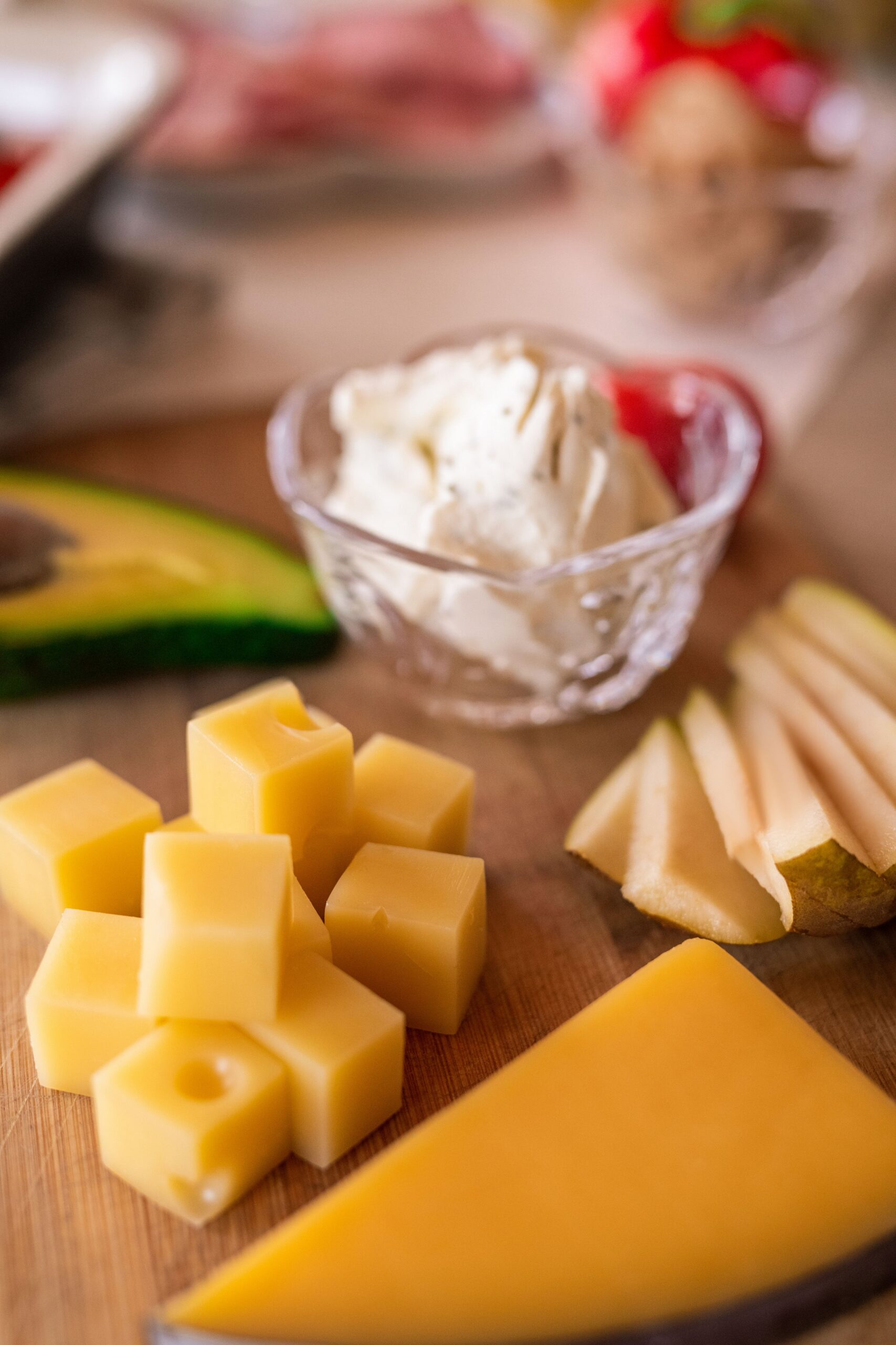 A cheese platter with several cheeses laid out on a board