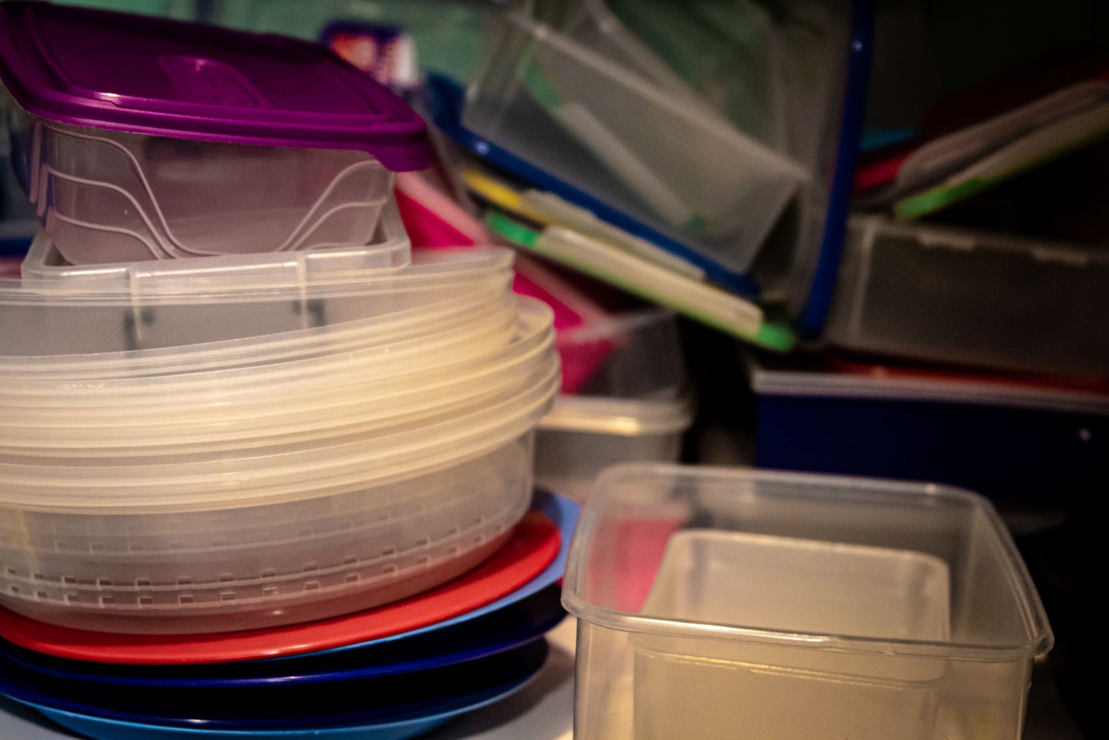 A stack of clear plastic food storage containers with lids