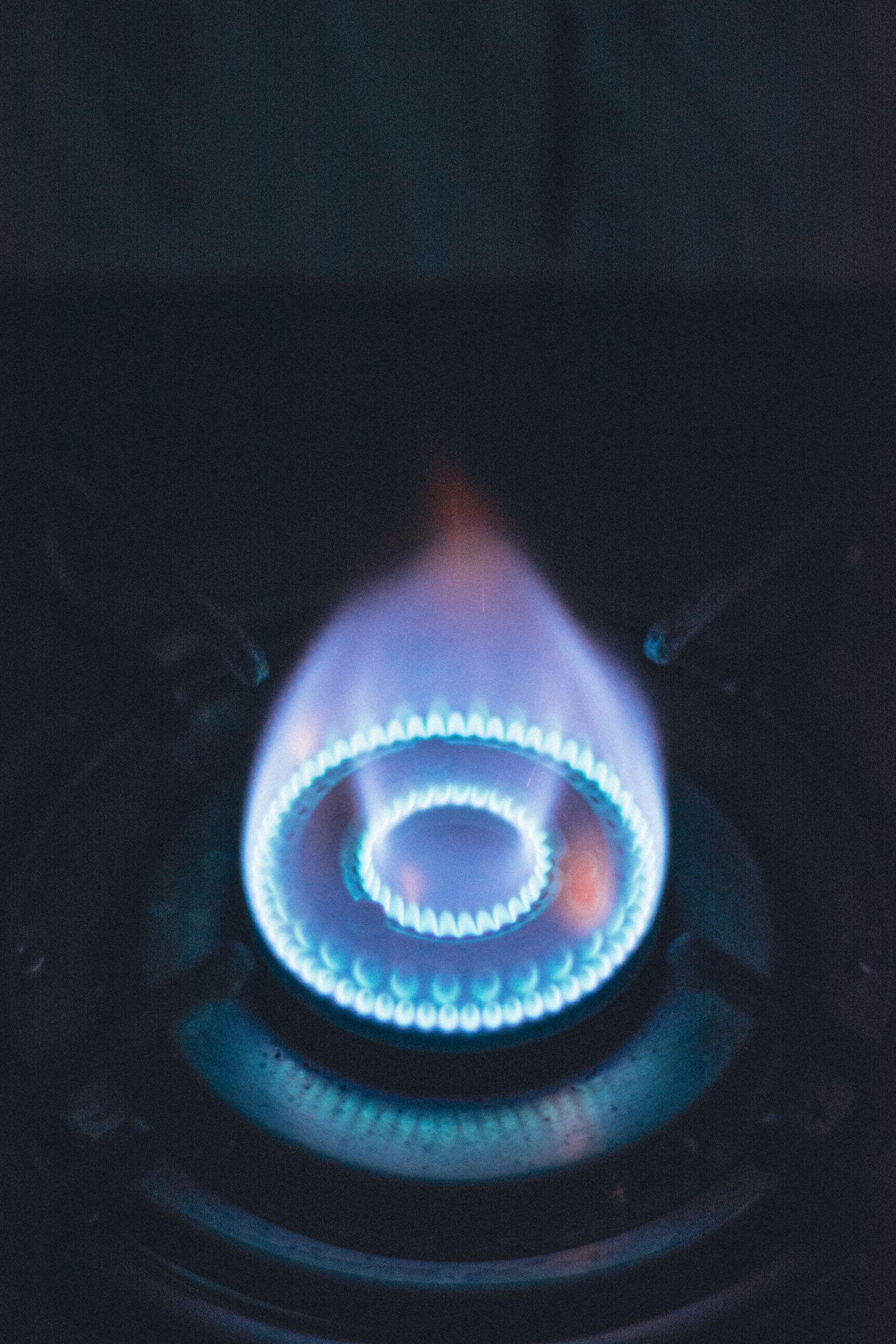 Close-up of a blue flame on a gas stove burner