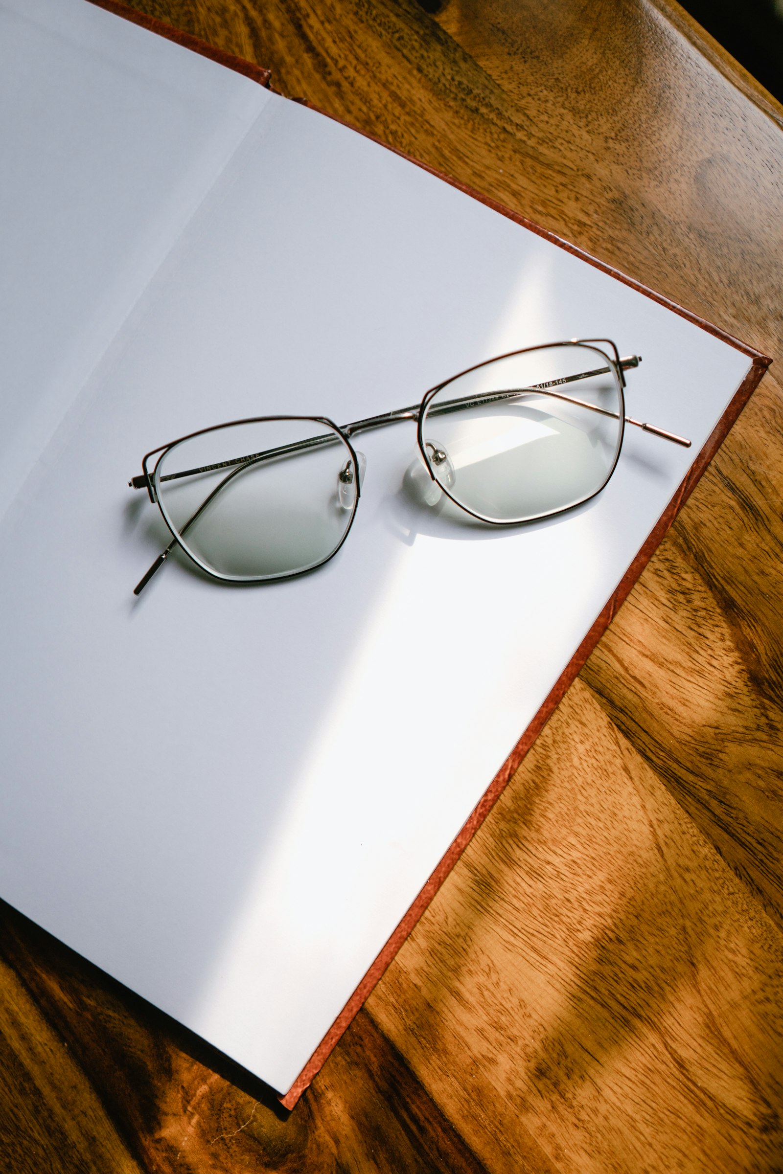 Black-framed eyeglasses on a white table