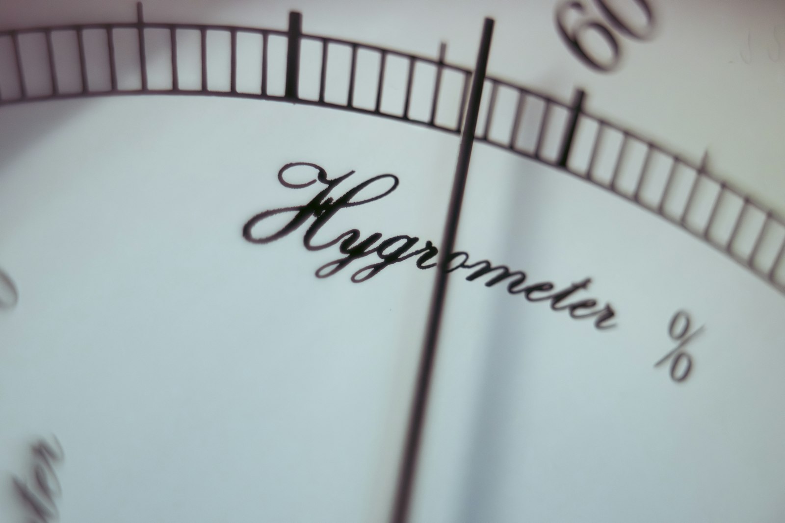 A close-up of a hygrometer dial with a needle over the percent scale